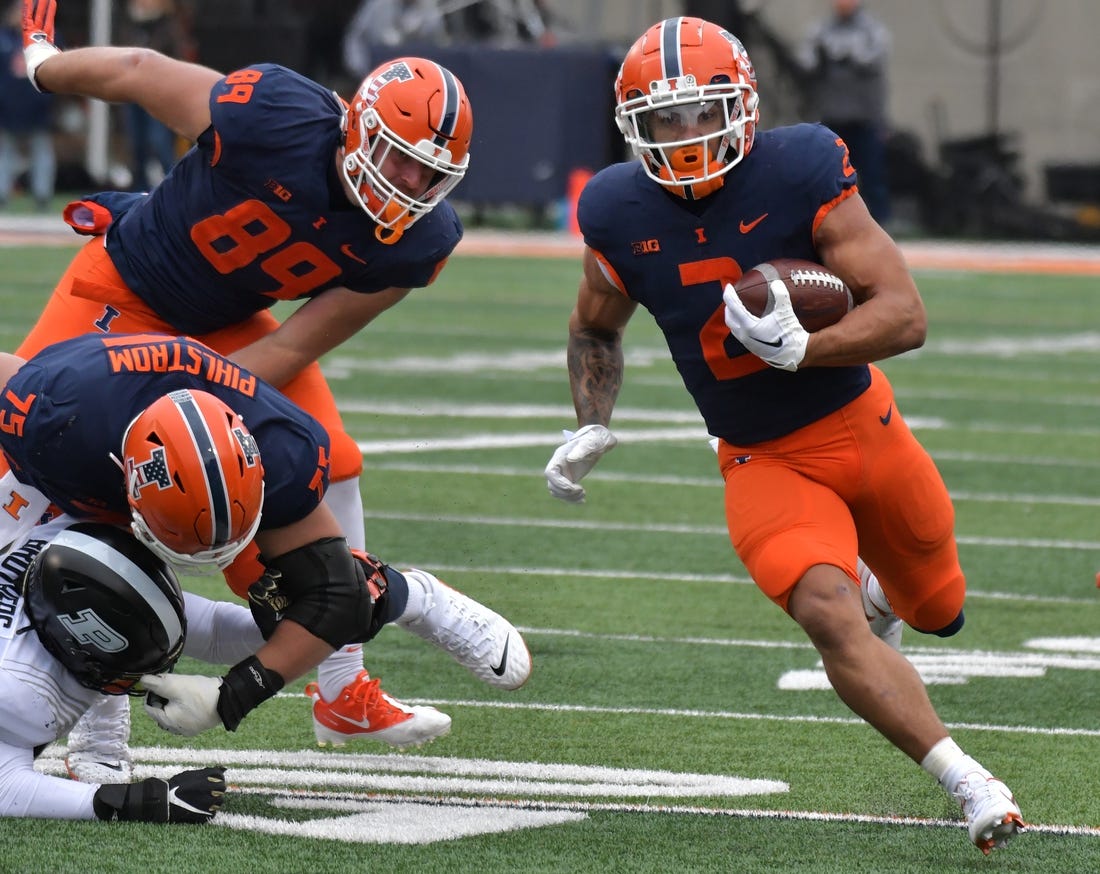Nov 12, 2022; Champaign, Illinois, USA;  Illinois Fighting Illini running back Chase Brown (2) finds an opening in the Purdue Boilermakers defense during the first half at Memorial Stadium. Mandatory Credit: Ron Johnson-USA TODAY Sports