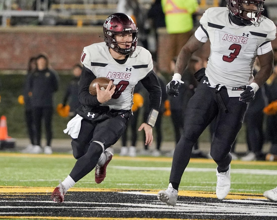 Nov 19, 2022; Columbia, Missouri, USA; New Mexico State Aggies quarterback Diego Pavia (10) runs the ball against the Missouri Tigers during the first half at Faurot Field at Memorial Stadium. Mandatory Credit: Denny Medley-USA TODAY Sports