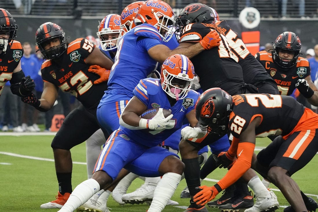 Dec 17, 2022; Las Vegas, NV, USA;  Florida Gators running back Trevor Etienne (7) runs with the ball through the Oregon State Beavers defense during the first half at the Las Vegas Bowl at Allegiant Stadium. Mandatory Credit: Lucas Peltier-USA TODAY Sports