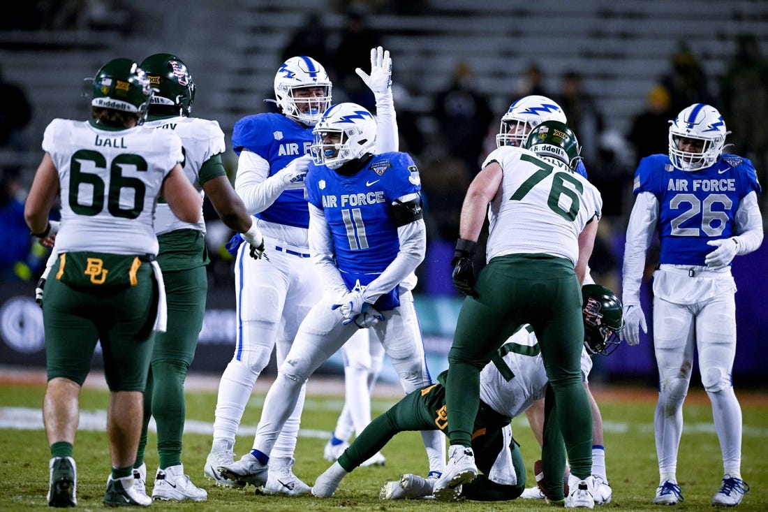 Dec 22, 2022; Fort Worth, TX, USA; Air Force Falcons safety Camby Goff (11) celebrates after tacking Baylor Bears quarterback Blake Shapen (12) for a loss during the first half in the 2022 Armed Forces Bowl at Amon G. Carter Stadium. Mandatory Credit: Jerome Miron-USA TODAY Sports