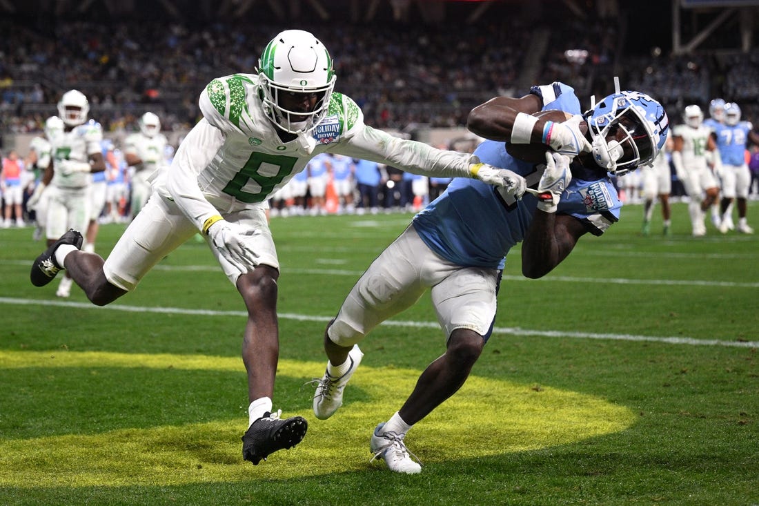 Dec 28, 2022; San Diego, CA, USA; North Carolina Tar Heels wide receiver Andre Greene Jr. (1) catches a touchdown pass while defended by Oregon Ducks defensive back Dontae Manning (8) during the first quarter of the 2022 Holiday Bowl at Petco Park. Mandatory Credit: Orlando Ramirez-USA TODAY Sports