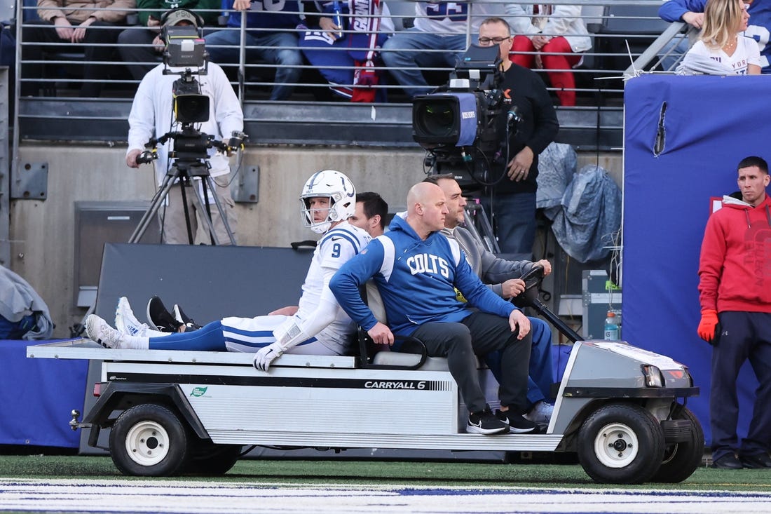 Jan 1, 2023; East Rutherford, New Jersey, USA; Indianapolis Colts quarterback Nick Foles (9) is driven off the field after an injury during the first half against the New York Giants at MetLife Stadium. Mandatory Credit: Vincent Carchietta-USA TODAY Sports