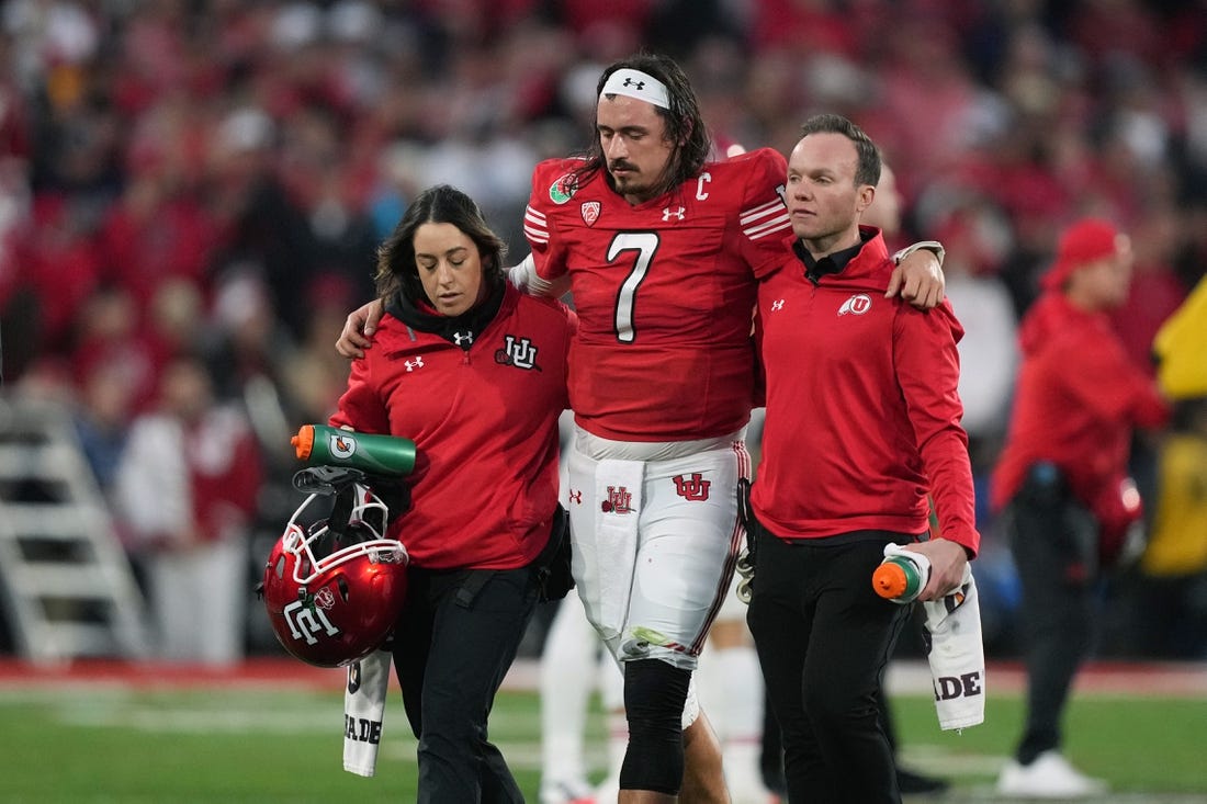 Jan 2, 2023; Pasadena, California, USA; Utah Utes quarterback Cameron Rising (7) walks with assistance off the field in the second half against the Penn State Nittany Lions of the 109th Rose Bowl game at the Rose Bowl. Mandatory Credit: Kirby Lee-USA TODAY Sports