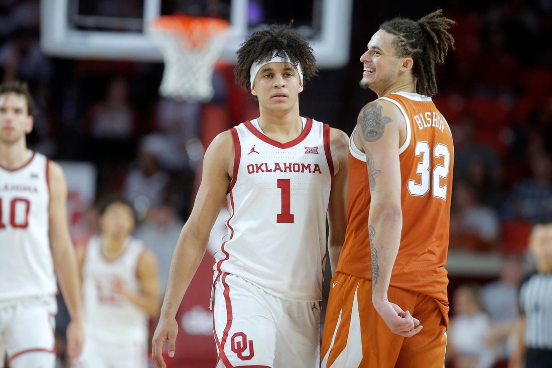 Texas Longhorns forward Christian Bishop (32) smiles as he walks past Oklahoma Sooners forward Jalen Hill (1) during an NCAA men's college basketball game between the University of Oklahoma and Texas at Lloyd Noble Center in Norman, Okla., Saturday, Dec. 31, 2022. Texas won 70-69.

Oklahoma Vs Texas Basketball