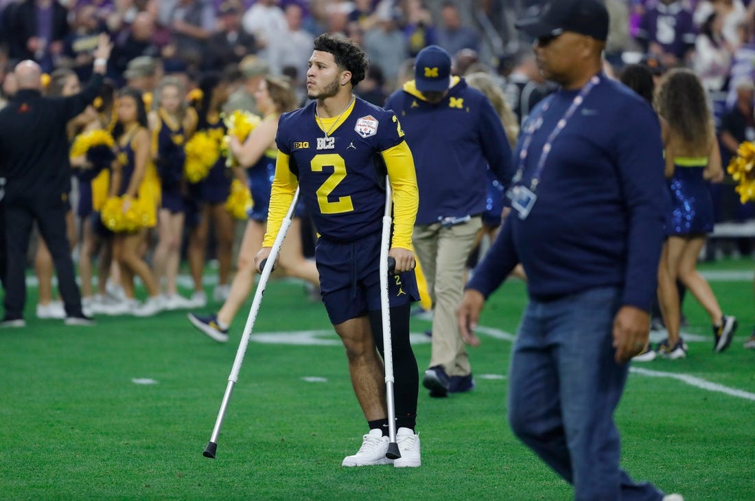 Michigan running back Blake Corum (2) is seen on the field on crutches before the start of the Fiesta Bowl against TCU on Saturday, Dec. 31 at State Farm Stadium in Glendale, Ariz.

H3 3755