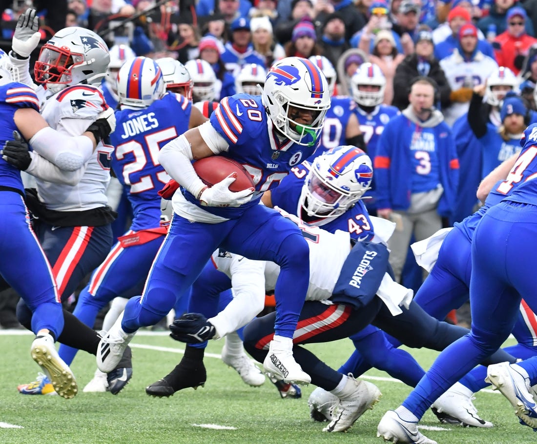 Jan 8, 2023; Orchard Park, New York, USA; Buffalo Bills running back Nyheim Hines (20) breaks through the New England Patriots special team to score a touchdown  on the opening kickoff at Highmark Stadium. Mandatory Credit: Mark Konezny-USA TODAY Sports