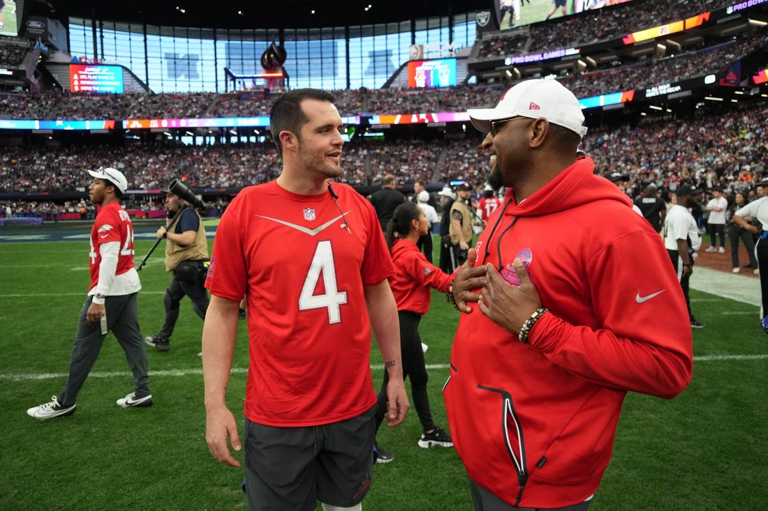 Feb 5, 2023; Paradise, Nevada, USA; AFC quarterback Derek Carr of the Las Vegas Raiders (4) talks with defensive coordinator Ray Lewis against the NFC during the Pro Bowl Games at Allegiant Stadium. Mandatory Credit: Kirby Lee-USA TODAY Sports