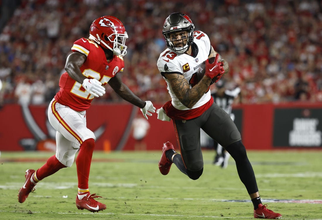 Oct 2, 2022; Tampa, Florida, USA; Tampa Bay Buccaneers wide receiver Mike Evans (13) runs with the ball as Kansas City Chiefs cornerback Rashad Fenton (27) defends during the first half at Raymond James Stadium. Mandatory Credit: Kim Klement-USA TODAY Sports