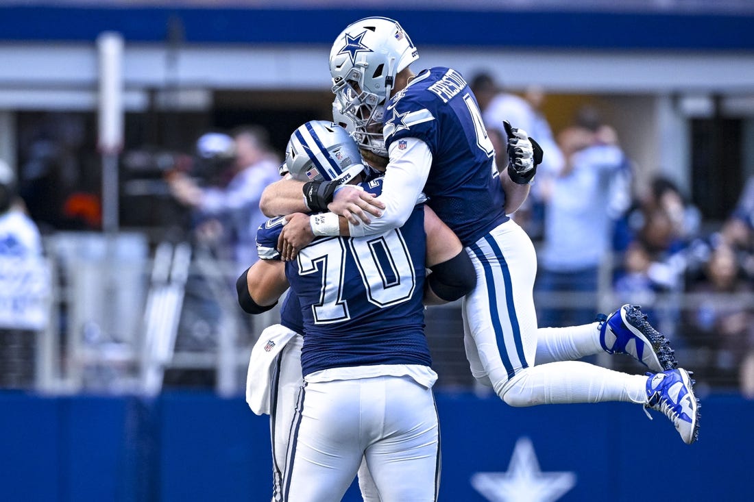 Oct 30, 2022; Arlington, Texas, USA; Dallas Cowboys quarterback Dak Prescott (4) and guard Zack Martin (70) celebrates a touchdown  scored by running back Tony Pollard (not pictured) during the second half against the Chicago Bears at AT&T Stadium. Mandatory Credit: Jerome Miron-USA TODAY Sports