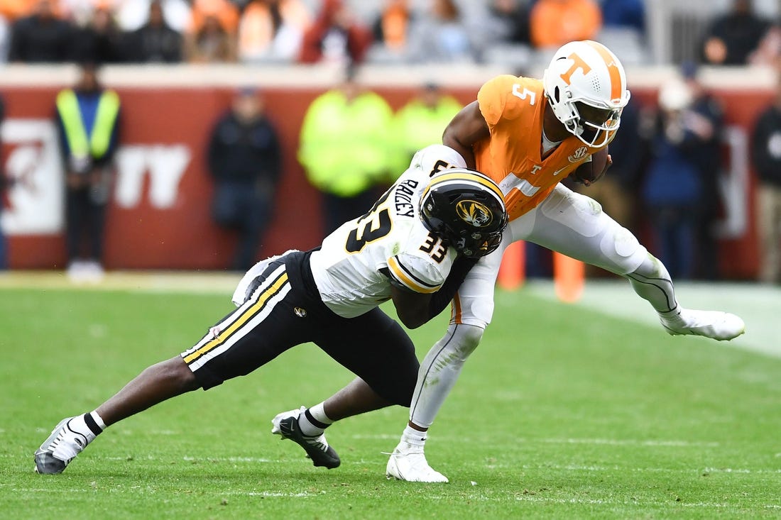 ***DUP***Tennessee quarterback Hendon Hooker (5)/Tennessee defensive back Kamal Hadden(5) is pulled down by Missouri linebacker Chad Bailey (33) during the NCAA college football game on Saturday, November 12, 2022 in Knoxville, Tenn.

Ut Vs Missouri