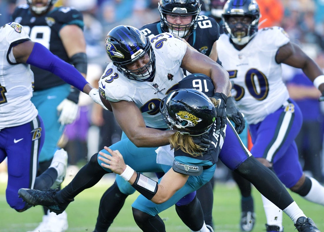Baltimore Ravens defensive tackle Calais Campbell (93) takes Jacksonville Jaguars quarterback Trevor Lawrence (16) to the turf with under two minutes to play in the game. The Jacksonville Jaguars hosted the Baltimore Ravens at TIAA Bank Field in Jacksonville, FL Sunday, November 27, 2022. The Jaguars got momentum late in the game to win 28 to 27 over the Ravens. [Bob Self/Florida Times-Union]

Jki 112722 Bs Jaguars Vs R 18