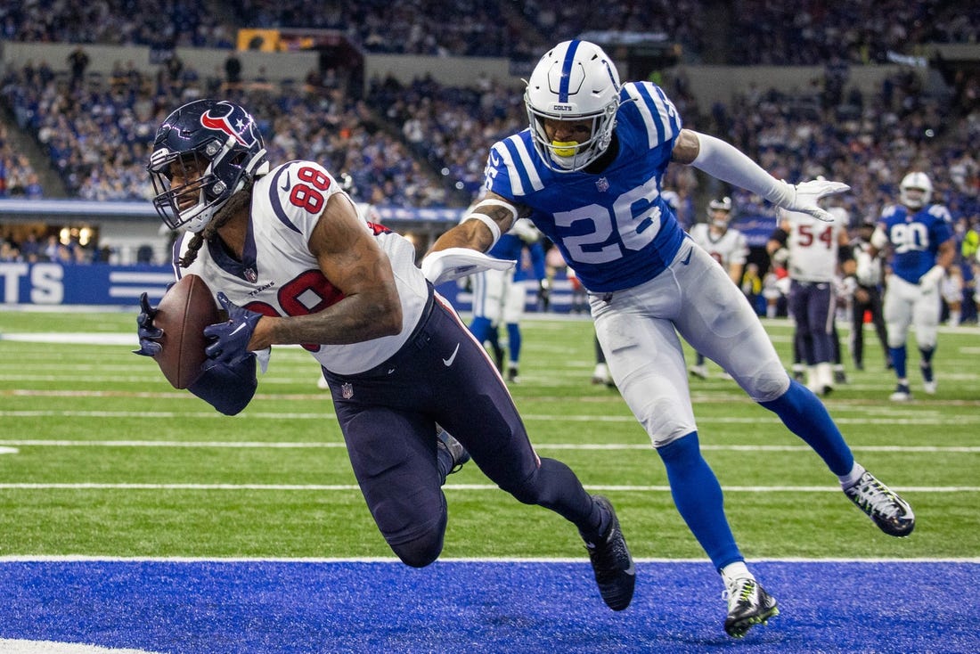 Jan 8, 2023; Indianapolis, Indiana, USA; Houston Texans tight end Jordan Akins (88) catches a touchdown pass while Indianapolis Colts safety Rodney McLeod Jr. (26) defends in the third quarter at Lucas Oil Stadium. Mandatory Credit: Trevor Ruszkowski-USA TODAY Sports