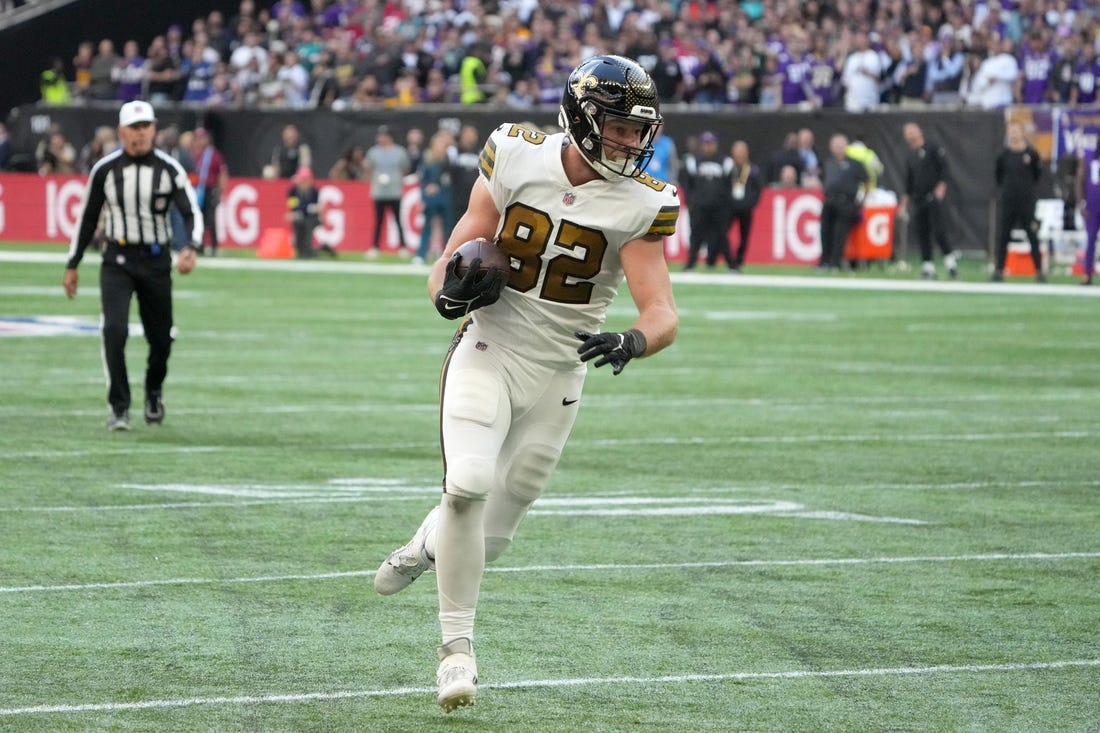 Oct 2, 2022; London, United Kingdom; New Orleans Saints tight end Adam Trautman (82) carries the ball in the second half against the Minnesota Vikings during an NFL International Series game at Tottenham Hotspur Stadium. The Vikings defeated the Saints 28-25. Mandatory Credit: Kirby Lee-USA TODAY Sports