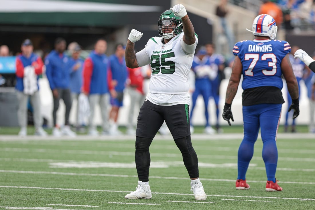 Nov 6, 2022; East Rutherford, New Jersey, USA; New York Jets defensive tackle Quinnen Williams (95) celebrates a defensive stop  being Buffalo Bills offensive tackle Dion Dawkins (73) during the second half at MetLife Stadium. Mandatory Credit: Vincent Carchietta-USA TODAY Sports