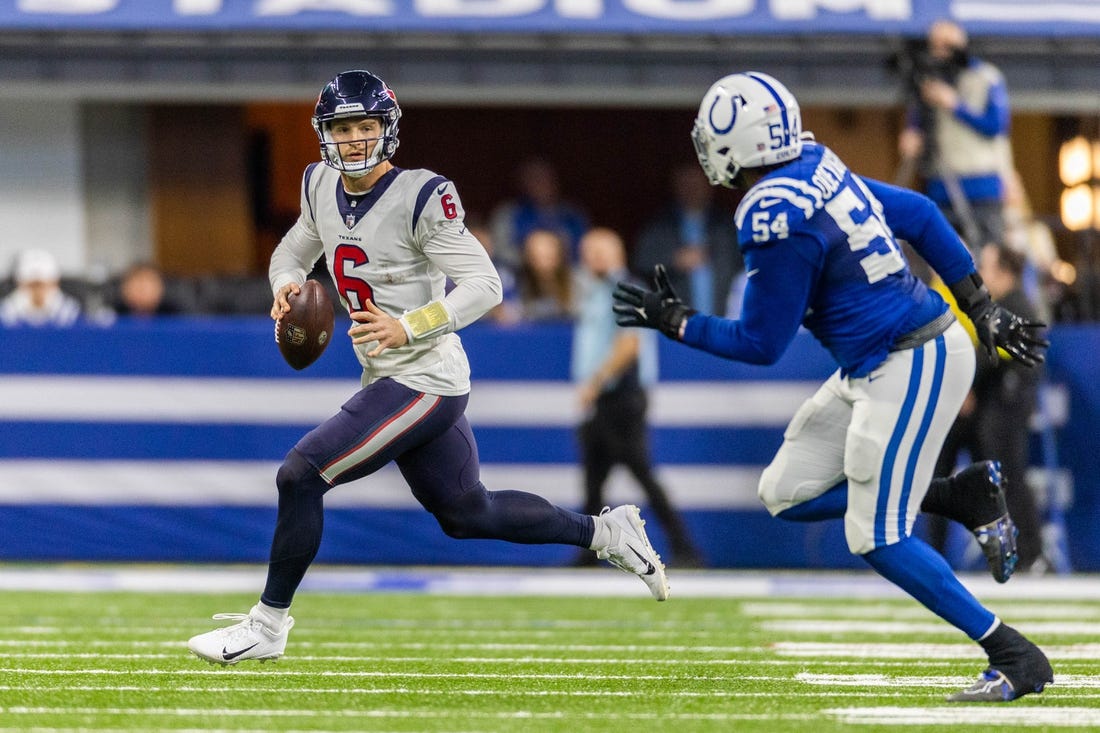 Jan 8, 2023; Indianapolis, Indiana, USA; Houston Texans quarterback Jeff Driskel (6) runs to pass the ball while Indianapolis Colts defensive end Dayo Odeyingbo (54) defends in the first half at Lucas Oil Stadium. Mandatory Credit: Trevor Ruszkowski-USA TODAY Sports