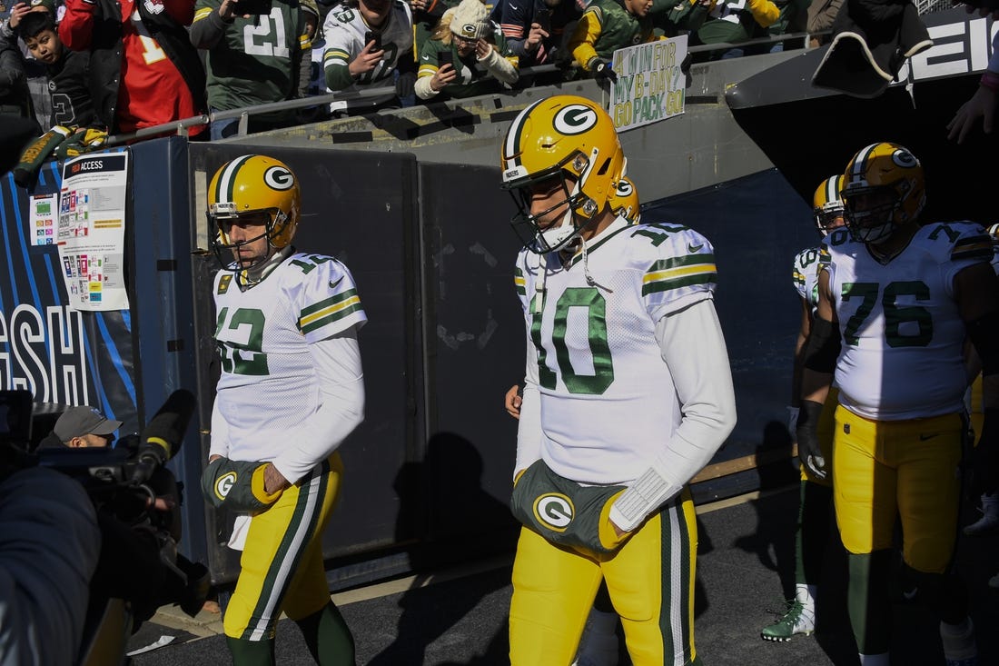 Dec 4, 2022; Chicago, Illinois, USA;  Green Bay Packers quarterback Aaron Rodgers (12) and quarterback Jordan Love (10) during warmups before a game against the Chicago Bears at Soldier Field. Mandatory Credit: Matt Marton-USA TODAY Sports