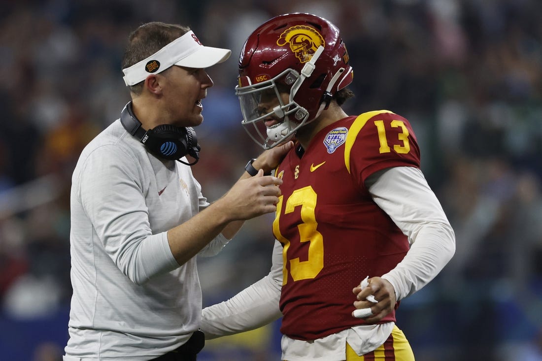 Jan 2, 2023; Arlington, Texas, USA; USC Trojans head coach Lincoln Riley talks to quarterback Caleb Williams (13) during the game against the Tulane Green Wave in the 2023 Cotton Bowl at AT&T Stadium. Mandatory Credit: Tim Heitman-USA TODAY Sports