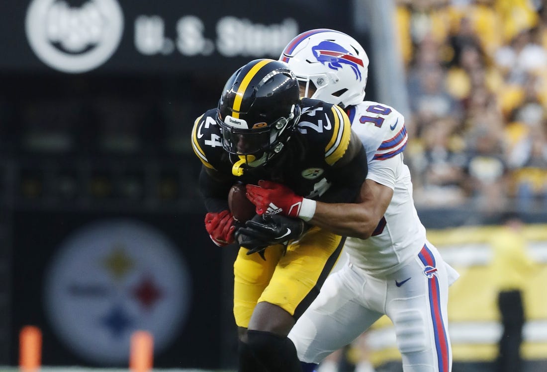 Aug 19, 2023; Pittsburgh, Pennsylvania, USA; Pittsburgh Steelers cornerback Joey Porter Jr. (24) is tackled after intercepting a pass intended for Buffalo Bills wide receiver Khalil Shakir (10) during the second quarter at Acrisure Stadium. Mandatory Credit: Charles LeClaire-USA TODAY Sports
