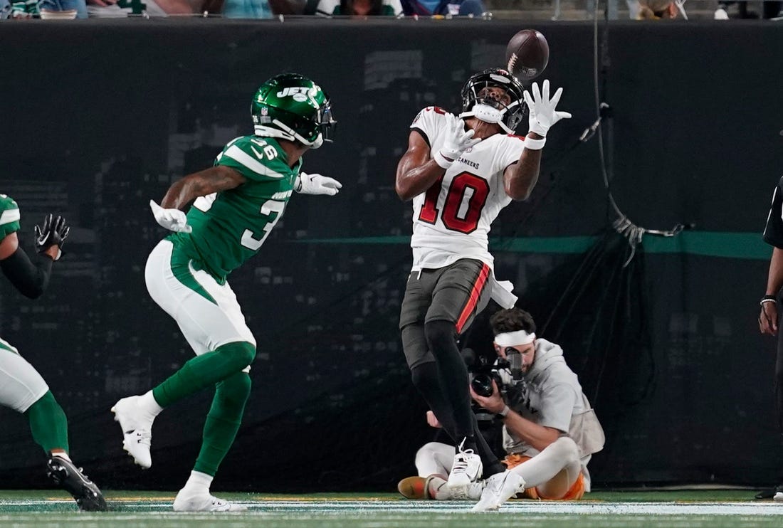 Tampa Bay Buccaneers wide receiver Trey Palmer (10) catches a touchdown pass as New York Jets cornerback Derrick Langford (36) looks on in the first half of a preseason NFL game at MetLife Stadium on Saturday, Aug. 19, 2023, in East Rutherford.