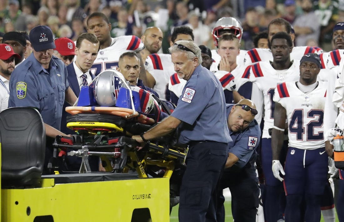 Aug 19, 2023; Green Bay, WI, USA;   Teammates look on as New England Patriots cornerback Isaiah Bolden (7) is taken off the field on a stretcher after a fourth quarter injury against the Green Bay Packers during their preseason football game at Lambeau Field. The game was suspended in the fourth quarter after the injury. Mandatory Credit: Dan Powers-USA TODAY Sports