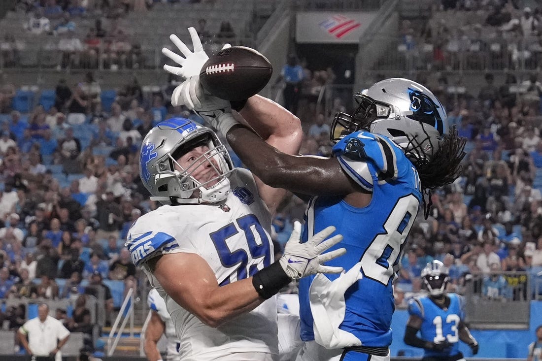Aug 25, 2023; Charlotte, North Carolina, USA;  Detroit Lions linebacker Trevor Nowaske (59) breaks up a pass in the end zone intended for Carolina Panthers tight end Ian Thomas (80) in the second quarter at Bank of America Stadium. Mandatory Credit: Bob Donnan-USA TODAY Sports