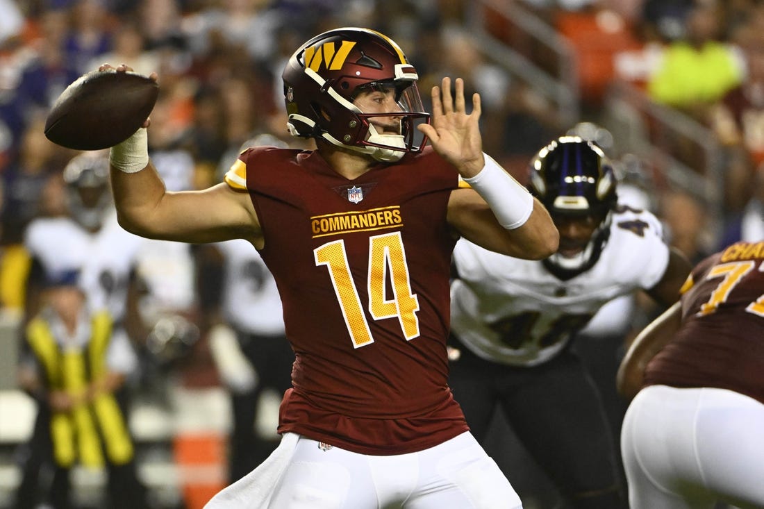 Aug 21, 2023; Landover, Maryland, USA; Washington Commanders quarterback Sam Howell (14) attempts a pass against the Baltimore Ravens during the first half at FedExField. Mandatory Credit: Brad Mills-USA TODAY Sports