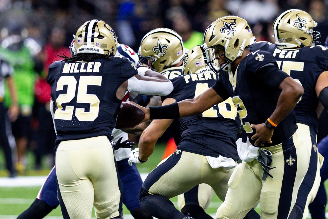 Aug 27, 2023; New Orleans, Louisiana, USA;  New Orleans Saints quarterback Jameis Winston (2) hands the ball off to running back Kendre Miller (25) against the Houston Texans during the first half at the Caesars Superdome. Mandatory Credit: Stephen Lew-USA TODAY Sports