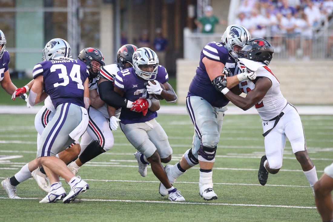 Sep 2, 2023; Manhattan, Kansas, USA; Kansas State Wildcats running back DJ Giddens (31) is tacked by Southeast Missouri State Redhawks defensive lineman LaWilliam Holmes (91) and linebacker Jacob Morrissey (44) during the second quarter at Bill Snyder Family Football Stadium. Mandatory Credit: Scott Sewell-USA TODAY Sports