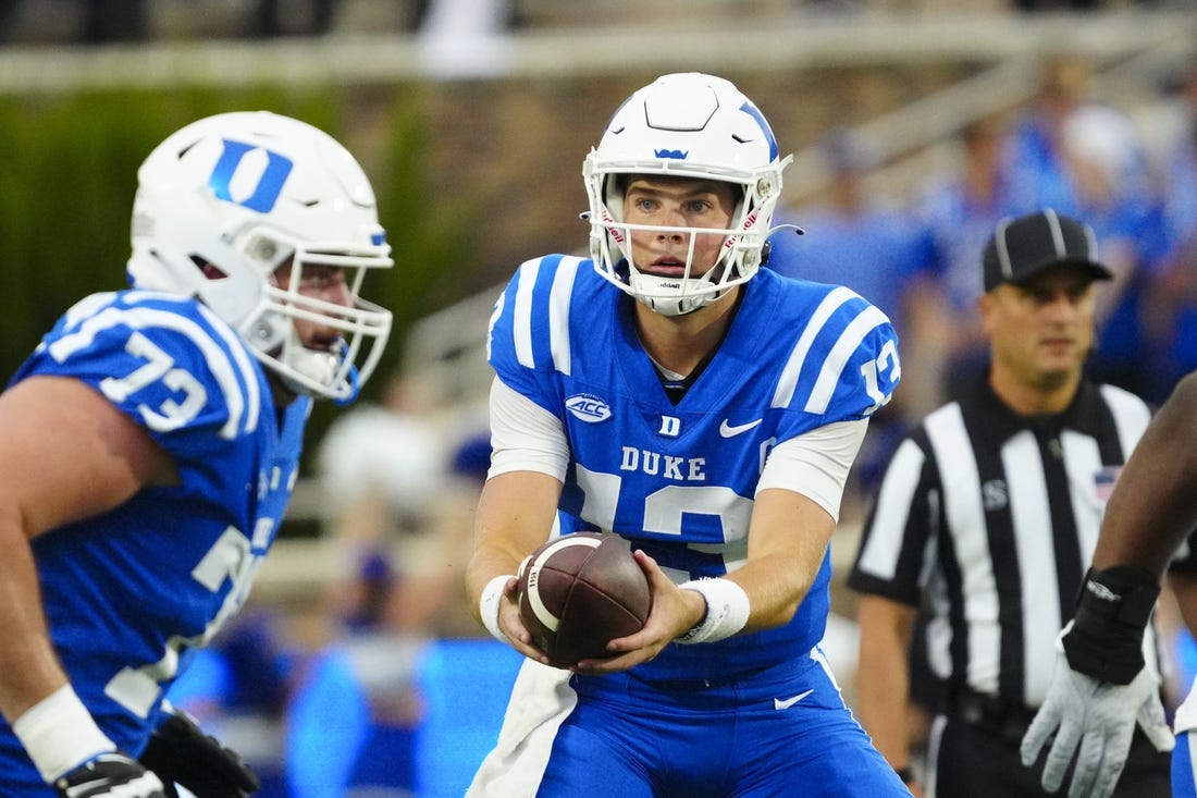 Sep 9, 2023; Durham, North Carolina, USA;  Duke Blue Devils quarterback Riley Leonard (13) gets ready to hand the ball off against the Lafayette Leopards during the first half at Wallace Wade Stadium. Mandatory Credit: James Guillory-USA TODAY Sports