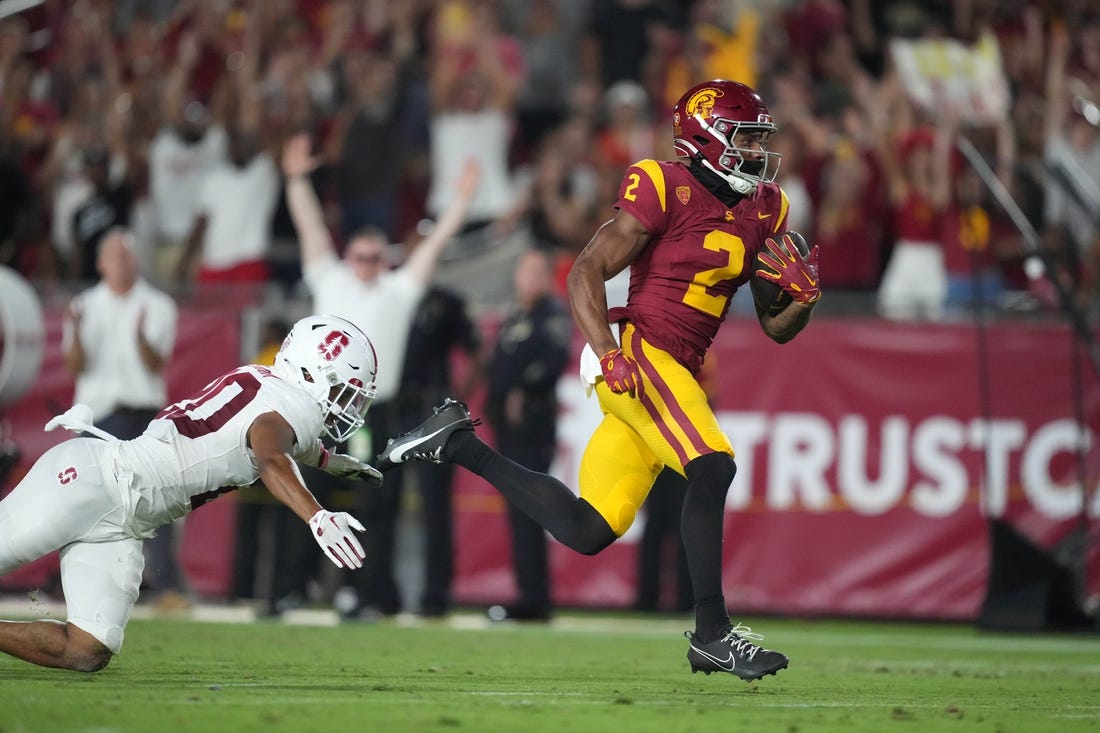 Sep 9, 2023; Los Angeles, California, USA; Southern California Trojans wide receiver Brenden Rice (2) scores on a 75-yard touchdown reception against Stanford Cardinal cornerback Jaden Slocum (20) in the first half at United Airlines Field at Los Angeles Memorial Coliseum. Mandatory Credit: Kirby Lee-USA TODAY Sports