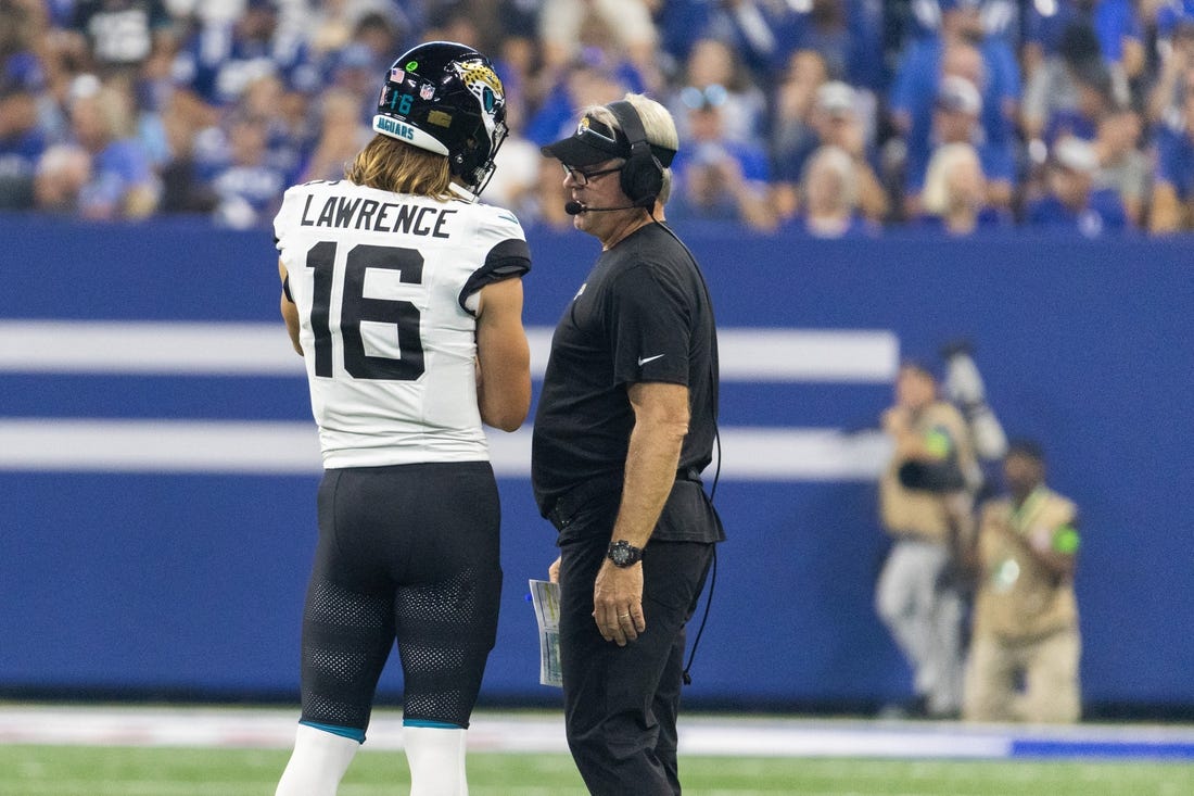 Sep 10, 2023; Indianapolis, Indiana, USA; Jacksonville Jaguars quarterback Trevor Lawrence (16) and head coach Doug Pederson talk during a timeout  in the second quarter against the Indianapolis Colts at Lucas Oil Stadium. Mandatory Credit: Trevor Ruszkowski-USA TODAY Sports
