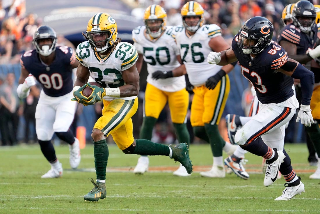Green Bay Packers running back Aaron Jones (33) runs for a touchdown during second half of their game against the Chicago Bears on Sunday, Sept. 10, 2023 at Soldier Field in Chicago.