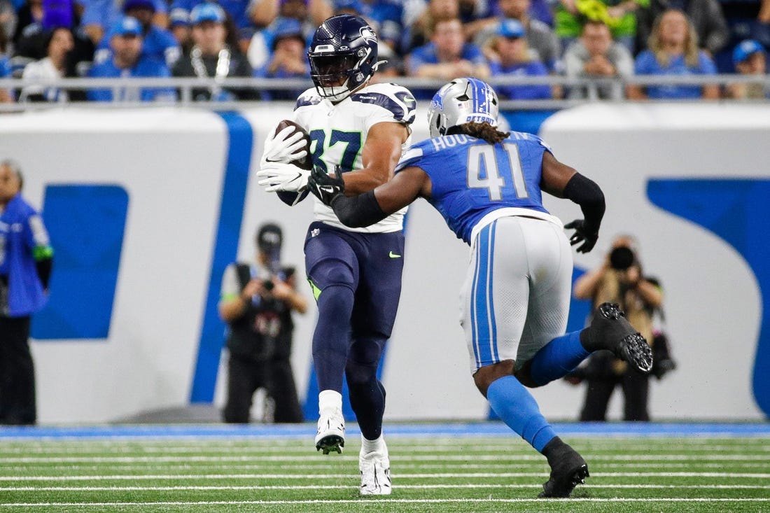 Detroit Lions pass rusher James Houston tackles Seattle Seahawks tight end Noah Fant after a catch during the first half at Ford Field in Detroit on Sunday, Sept. 17, 2023.