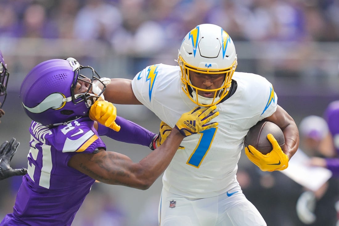 Sep 24, 2023; Minneapolis, Minnesota, USA; Los Angeles Chargers tight end Gerald Everett (7) runs after the catch against the Minnesota Vikings cornerback Akayleb Evans (21) in the first quarter at U.S. Bank Stadium. Mandatory Credit: Brad Rempel-USA TODAY Sports