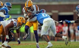 Sep 30, 2023; Oxford, Mississippi, USA; LSU Tigers quarterback Jayden Daniels (5) runs with the ball as Mississippi Rebels linebacker Monty Montgomery (8) makes the tackle during the first half at Vaught-Hemingway Stadium. Mandatory Credit: Petre Thomas-USA TODAY Sports