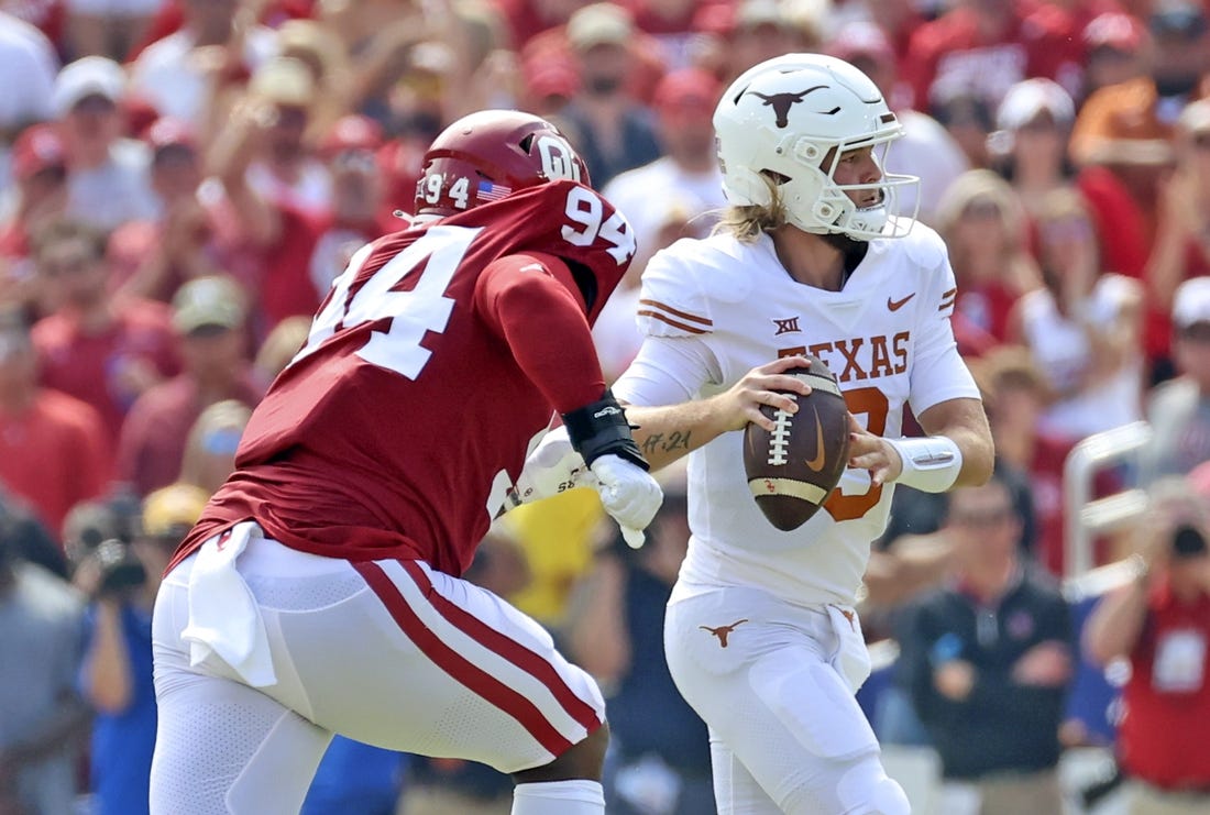 Oct 8, 2022; Dallas, Texas, USA;  Texas Longhorns quarterback Quinn Ewers (3) looks to throw as Oklahoma Sooners defensive lineman Isaiah Coe (94) chases during the game at the Cotton Bowl. Mandatory Credit: Kevin Jairaj-USA TODAY Sports
