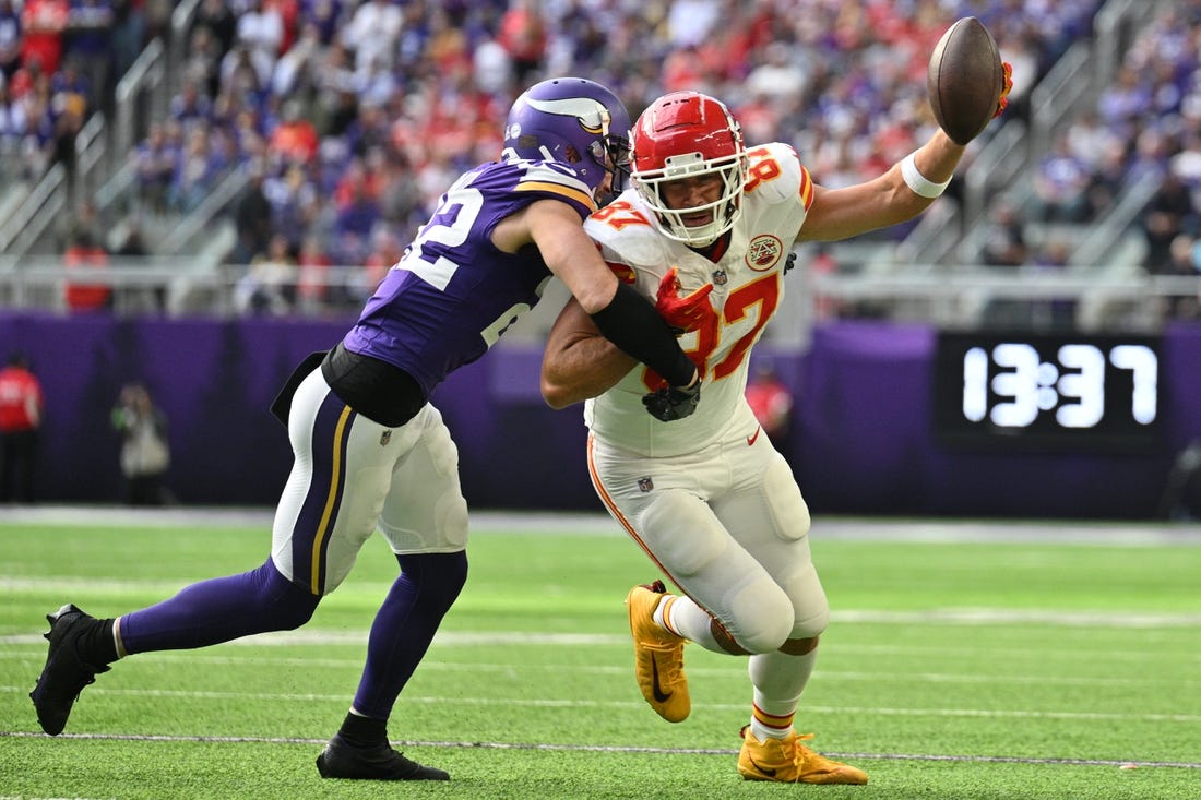 Oct 8, 2023; Minneapolis, Minnesota, USA; Kansas City Chiefs tight end Travis Kelce (87) gets yards after the catch as Minnesota Vikings safety Harrison Smith (22) makes a tackle during the second quarter at U.S. Bank Stadium. Mandatory Credit: Jeffrey Becker-USA TODAY Sports