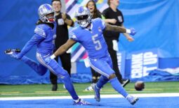 Lions receiver Jameson Williams celebrates with running back David Montgomery (5) after Montgomery's touchdown against the Panthers during the first half Sunday, Oct. 8, 2023, at Ford Field.