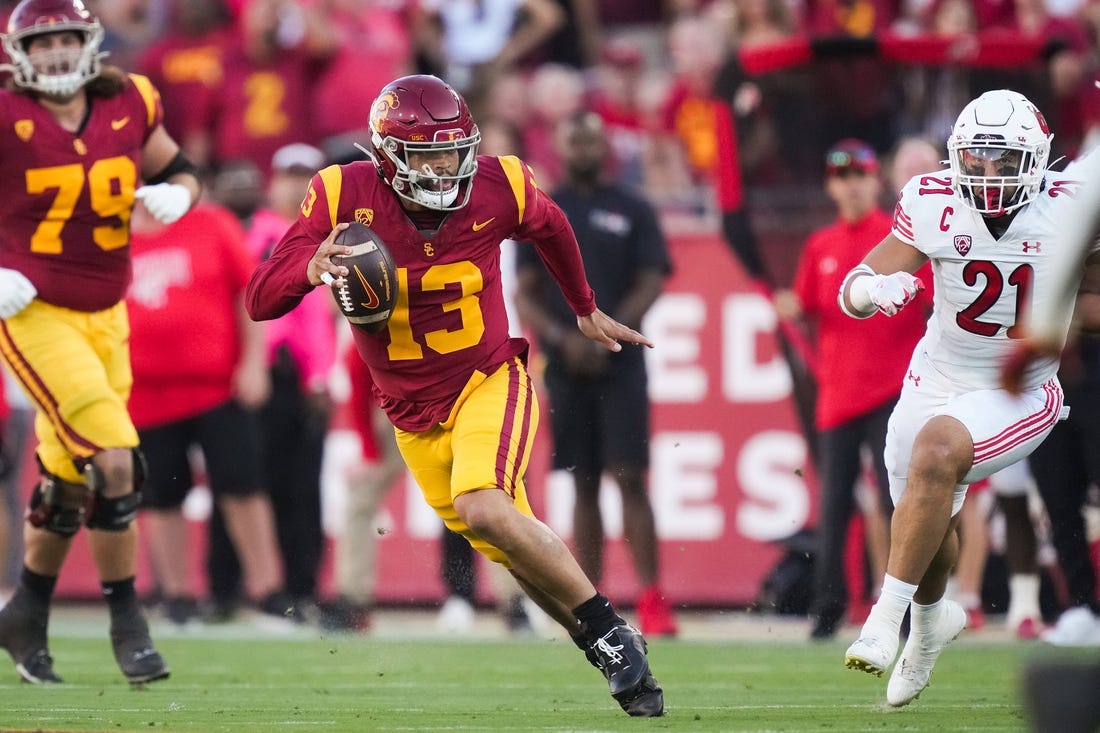 Oct 21, 2023; Los Angeles, California, USA; Southern California Trojans quarterback Caleb Williams (13) carries the ball against the Utah Utes in the first half at United Airlines Field at Los Angeles Memorial Coliseum. Mandatory Credit: Kirby Lee-USA TODAY Sports
