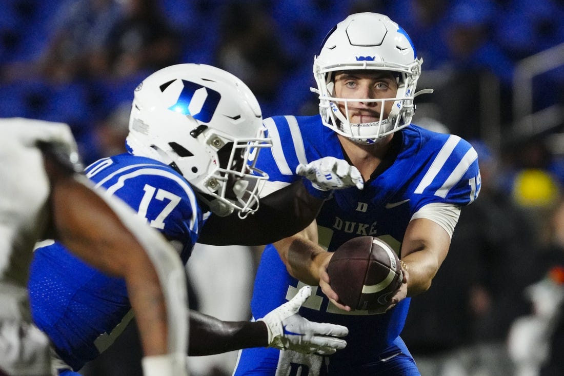 Sep 9, 2023; Durham, North Carolina, USA;  Duke Blue Devils quarterback Grayson Loftis (12) hands off the ball to  wide receiver Quran Boyd (17) against the Lafayette Leopards during the second half at Wallace Wade Stadium. Mandatory Credit: James Guillory-USA TODAY Sports