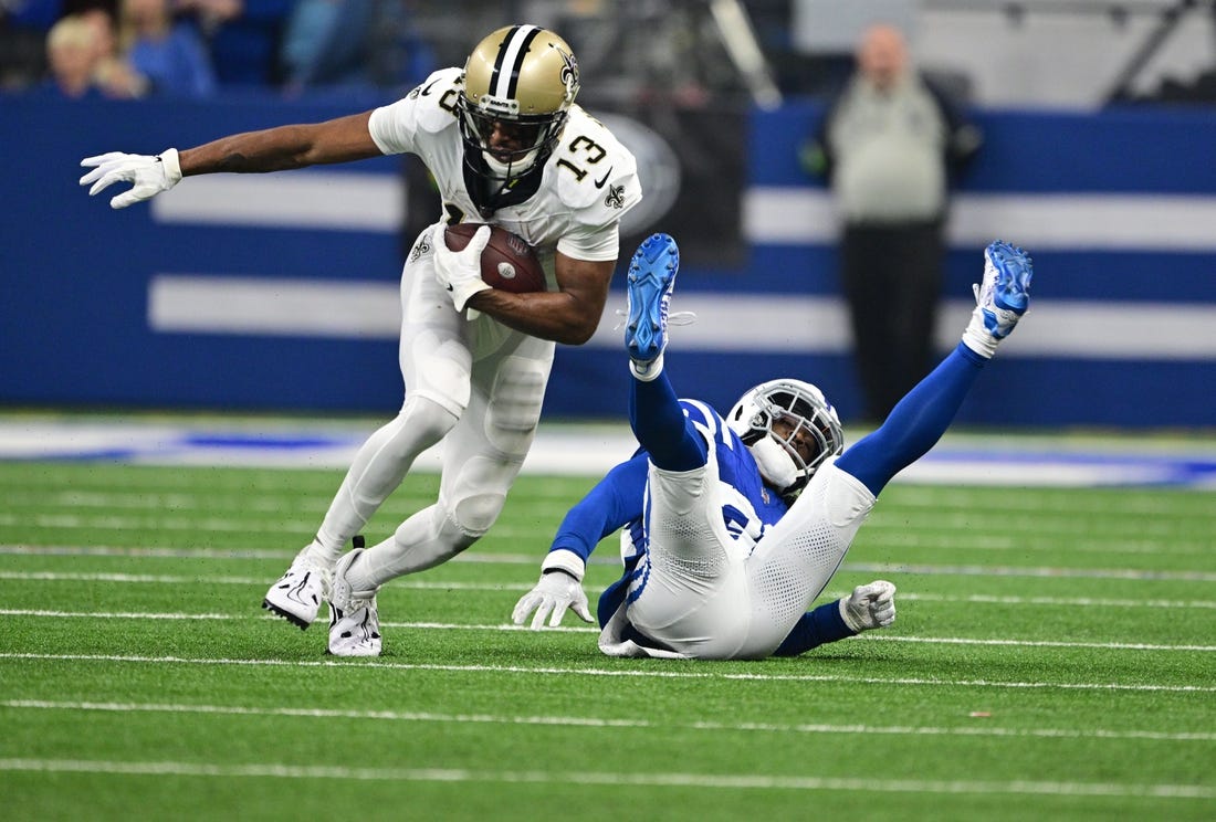 Oct 29, 2023; Indianapolis, Indiana, USA; New Orleans Saints wide receiver Michael Thomas (13) evades a tackle by Indianapolis Colts cornerback Tony Brown (38) during the first quarter at Lucas Oil Stadium. Mandatory Credit: Marc Lebryk-USA TODAY Sports