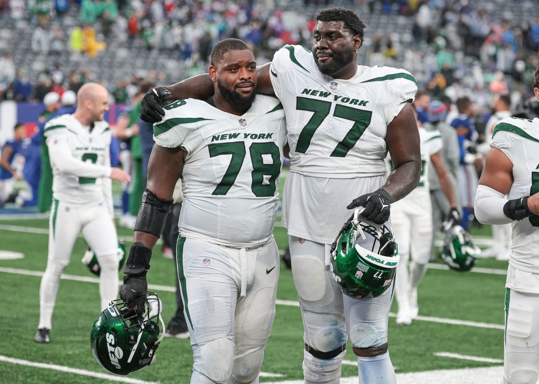 Oct 29, 2023; East Rutherford, New Jersey, USA; New York Jets guard Laken Tomlinson (78) and offensive tackle Mekhi Becton (77) walk off the field after defeating the New York Giants in overtime at MetLife Stadium. Mandatory Credit: Vincent Carchietta-USA TODAY Sports