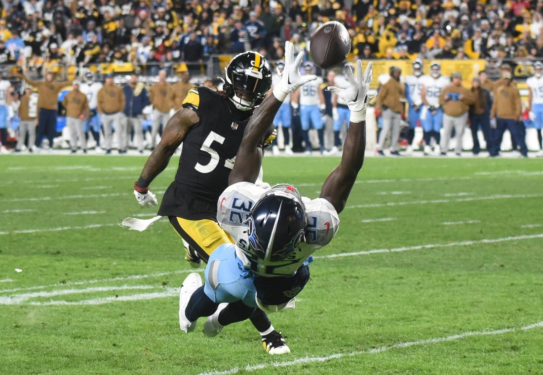 Nov 2, 2023; Pittsburgh, Pennsylvania, USA; The ball goes through hands of Tennessee Titans running back Tyjae Spears (32) as Pittsburgh Steelers linebacker Kwon Alexander (54) applies coverage during the second quarter at Acrisure Stadium. Mandatory Credit: Philip G. Pavely-USA TODAY Sports
