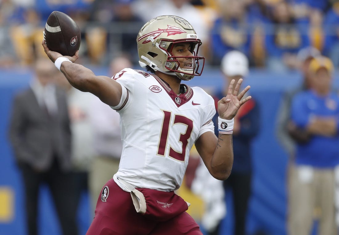 Nov 4, 2023; Pittsburgh, Pennsylvania, USA;  Florida State Seminoles quarterback Jordan Travis (13) passes the ball against the Pittsburgh Panthers during the first quarter at Acrisure Stadium. Mandatory Credit: Charles LeClaire-USA TODAY Sports