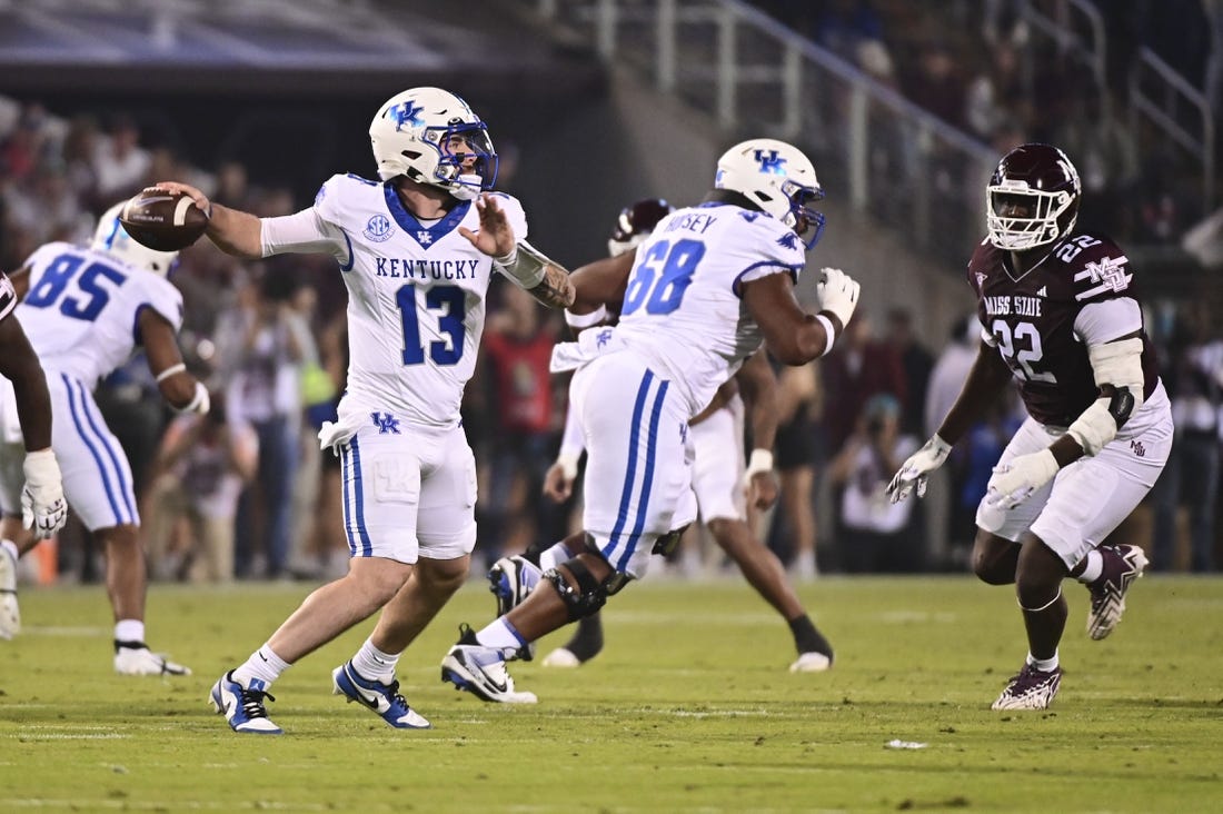 Nov 4, 2023; Starkville, Mississippi, USA; Kentucky Wildcats quarterback Devin Leary (13) makes a pass against the Mississippi State Bulldogs during the first quarter at Davis Wade Stadium at Scott Field. Mandatory Credit: Matt Bush-USA TODAY Sports