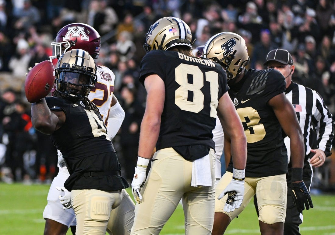 Nov 11, 2023; West Lafayette, Indiana, USA;  Purdue Boilermakers wide receiver Deion Burks (4) celebrates with tight end George Burhenn (81) and wide receiver Jaron Tibbs (13) after scoring a touchdown against the Minnesota Golden Gophers during the second half at Ross-Ade Stadium. Mandatory Credit: Robert Goddin-USA TODAY Sports