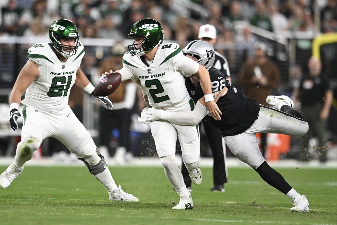 Nov 12, 2023; Paradise, Nevada, USA; New York Jets quarterback Zach Wilson (2) is tackled by Las Vegas Raiders defensive end Maxx Crosby (98) in the first quarter at Allegiant Stadium. Mandatory Credit: Candice Ward-USA TODAY Sports