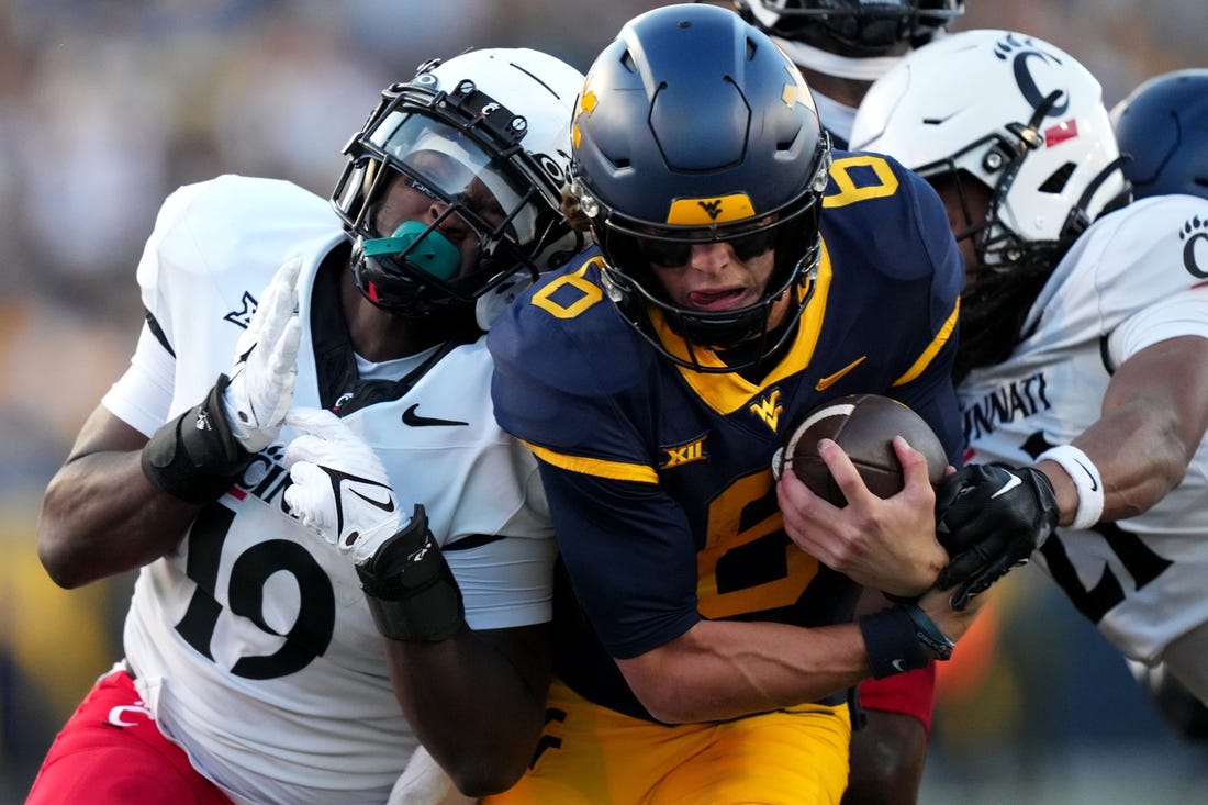 West Virginia Mountaineers quarterback Garrett Greene (6) carries the ball on a touchdown run in the third quarter during an NCAA college football game between the Cincinnati Bearcats and the West Virginia Mountaineers, Saturday, Nov. 18, 2023, at Milan Puskar Stadium in Morgantown, W. Va. The West Virginia Mountaineers won, 42-21.