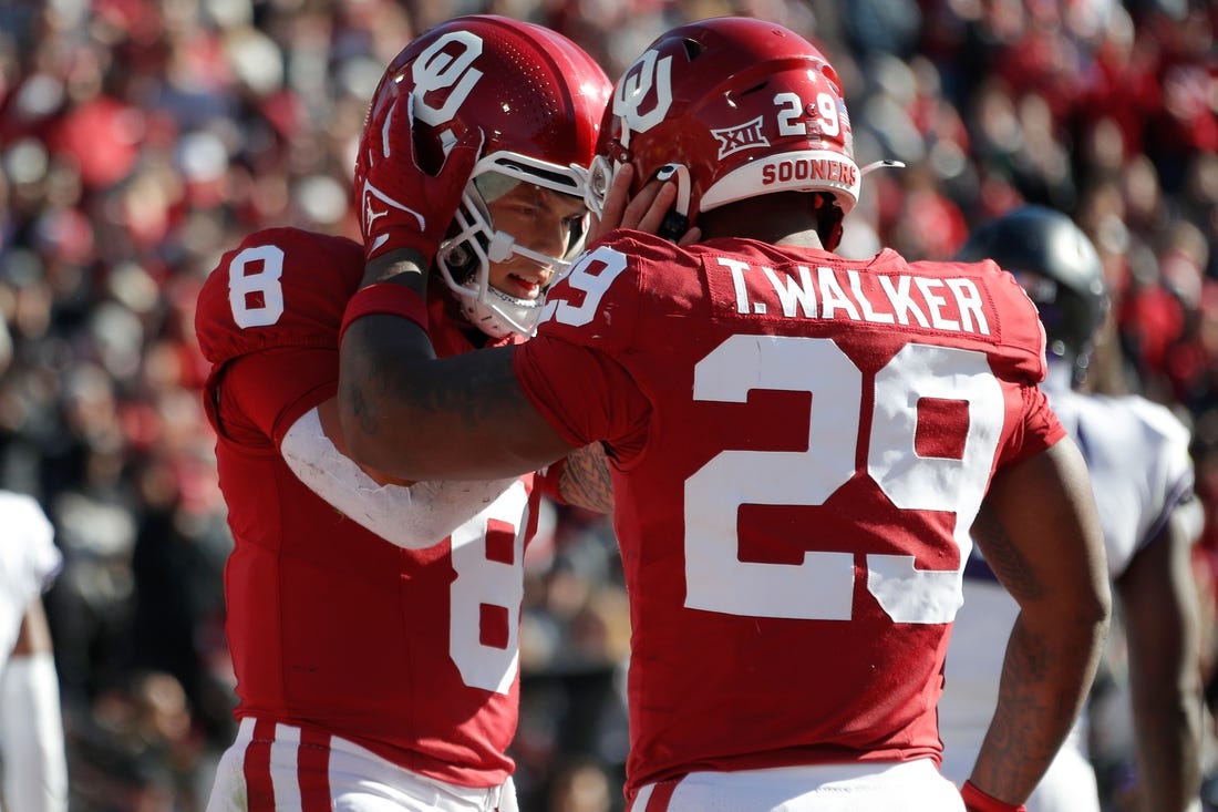 Nov 24, 2023; Norman, Oklahoma, USA; Oklahoma Sooners quarterback Dillon Gabriel (8) celebrates with running back Gavin Sawchuk (27) after a touchdown during the game against the TCU Horned Frogs  at Gaylord Family-Oklahoma Memorial Stadium. Mandatory Credit: Bryan Terry-USA TODAY Sports
