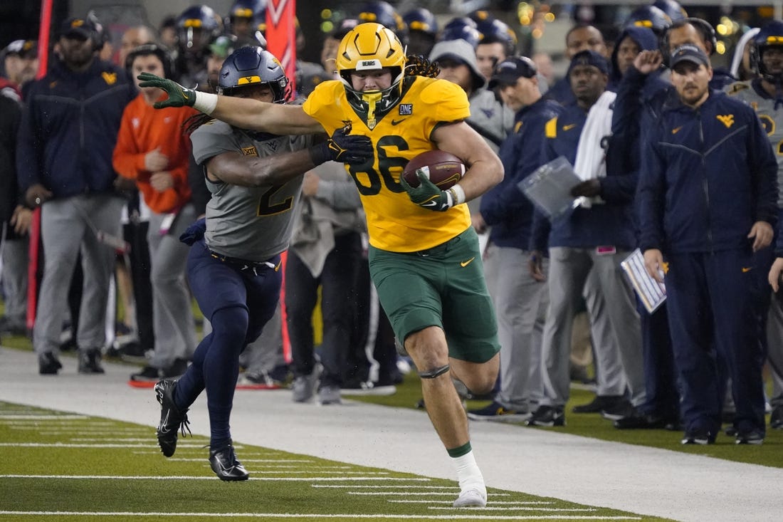 Nov 25, 2023; Waco, Texas, USA; Baylor Bears tight end Jake Roberts (86) runs after the catch past  West Virginia Mountaineers safety Aubrey Burks (2) during the first half at McLane Stadium. Mandatory Credit: Raymond Carlin III-USA TODAY Sports